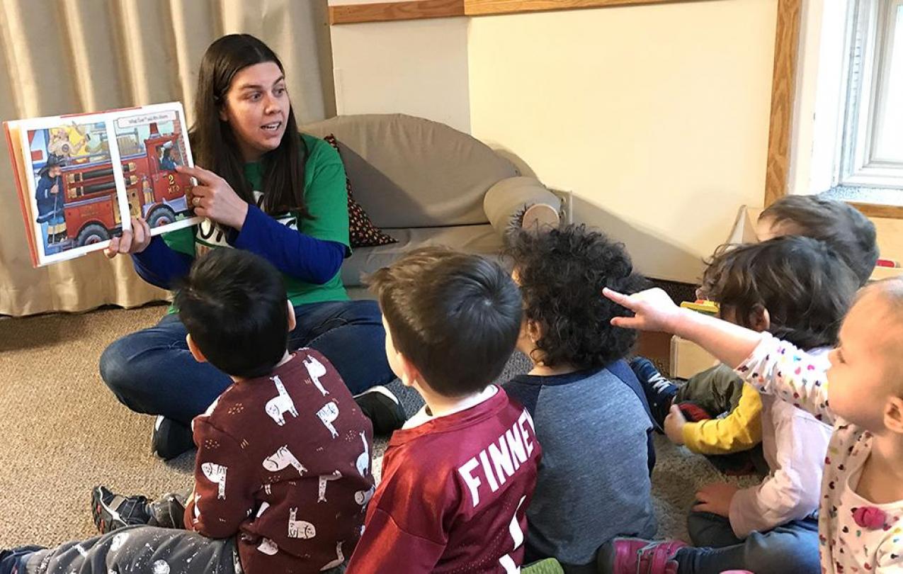 Heather reads to kids in the U of M CDC classroom.